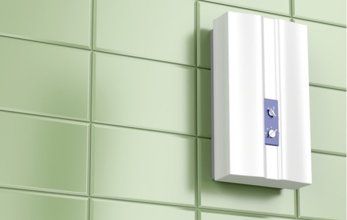 tankless water heater on green tiled wall